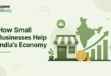 How Small Businesses Help India's Economy illustration featuring a local retail shop, India map, upward growth chart, rupee coin, and the RupeeMoney logo, representing the contribution of MSMEs and small businesses to India's economic growth.
