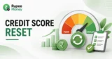 Credit Score Reset banner showing a credit score gauge, upward growth chart, rupee coins, financial checklist, and credit improvement indicators.