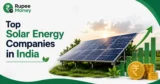 Top Solar Energy Companies in India banner featuring solar panels, renewable energy infrastructure, rising financial charts, rupee coins, and Rupee Money branding.