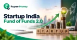 Startup India Fund of Funds 2.0 banner featuring startup funding, growing investment capital, entrepreneur-focused business elements, rising growth arrow, and RupeeMoney branding.