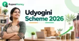 Udyogini Scheme 2026 banner featuring an Indian woman entrepreneur, sewing and business equipment, a laptop, rising coin stacks and a growth arrow, with RupeeMoney branding, representing financial support for women entrepreneurs.